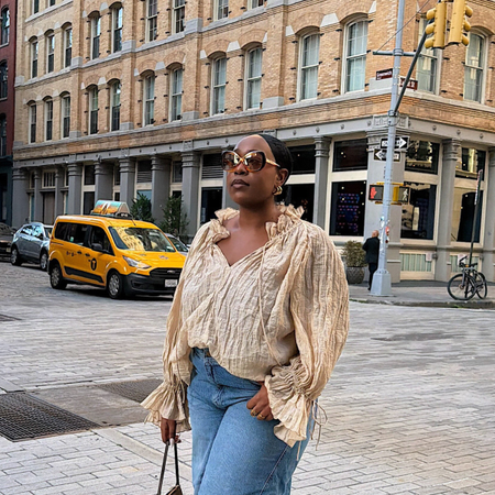 An image of a woman wearing long loose denim shorts outfit summer 2026