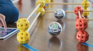 Image of a Sphero bolt finding its way around a maze taped on the floor