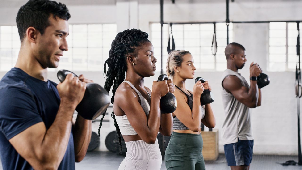 Exercise class holding kettlebells