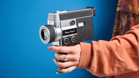 Person holding the Camp Snap CS-8 video camera