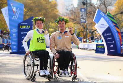 Tatyana McFadden of the United States and Marcel Hug of Switzerland celebrate with their medals after finishing first