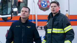 Don and Buck staring at something in front of an ambulance on 9-1-1: Nashville.