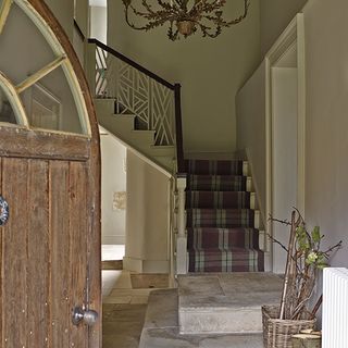 rustic entrance hall with tartan stair runner