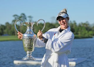 Nelly Korda smiles while lifting the 2024 Chevron Championship trophy