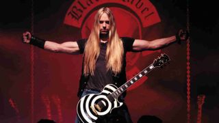 Zakk Wylde posing for a photograph with his arms outstretched