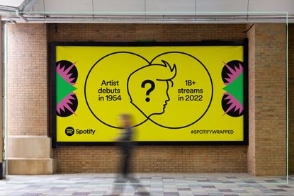 A billboard with a yellow Spotify Wrapped poster on it