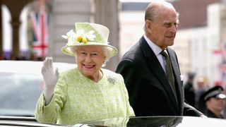 WINDSOR, ENGLAND - APRIL 21: Queen Elizabeth II and Prince Philip, Duke of Edinburgh wave from the top of an open Range Rover on the monarch's 90th Birthday on April 21, 2016 in Windsor, England. Today is Queen Elizabeth II's 90th Birthday. The Queen and Duke of Edinburgh will be carrying out engagements in Windsor.