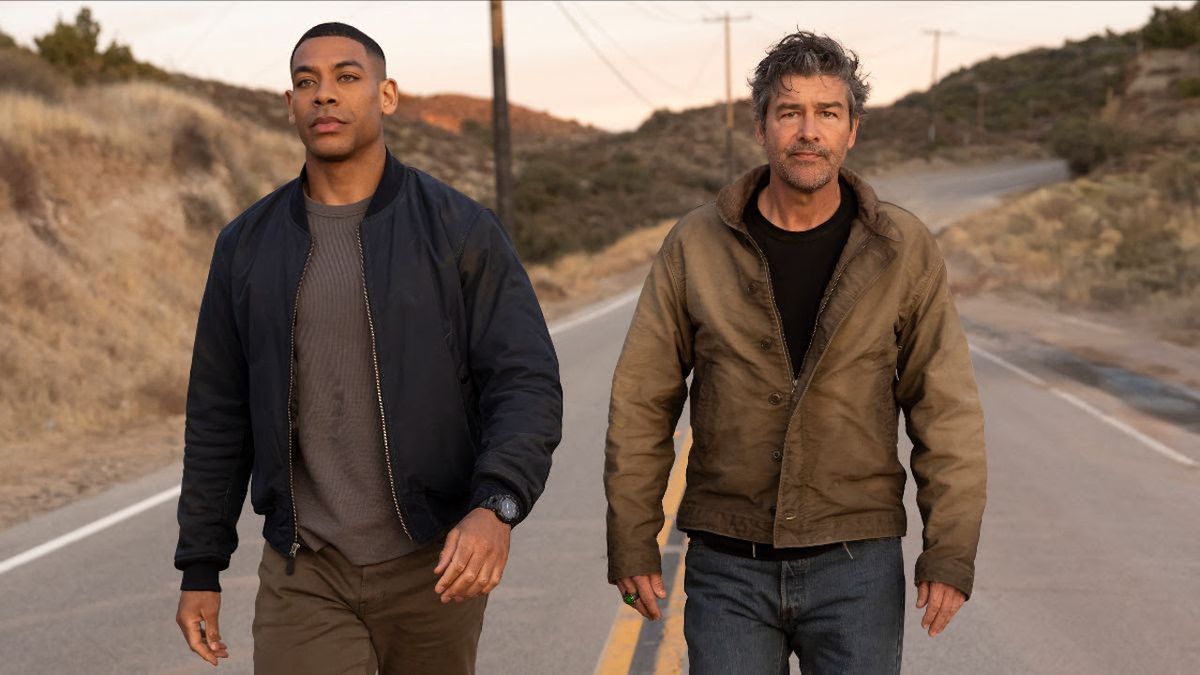 Aaron Pierre and Kyle Chandler walking down country road in Lanterns