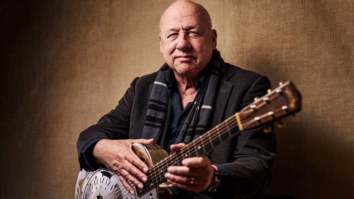 Mark Knopfler holds one of his prized resonator guitars