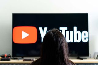 Person watching YouTube on a TV set