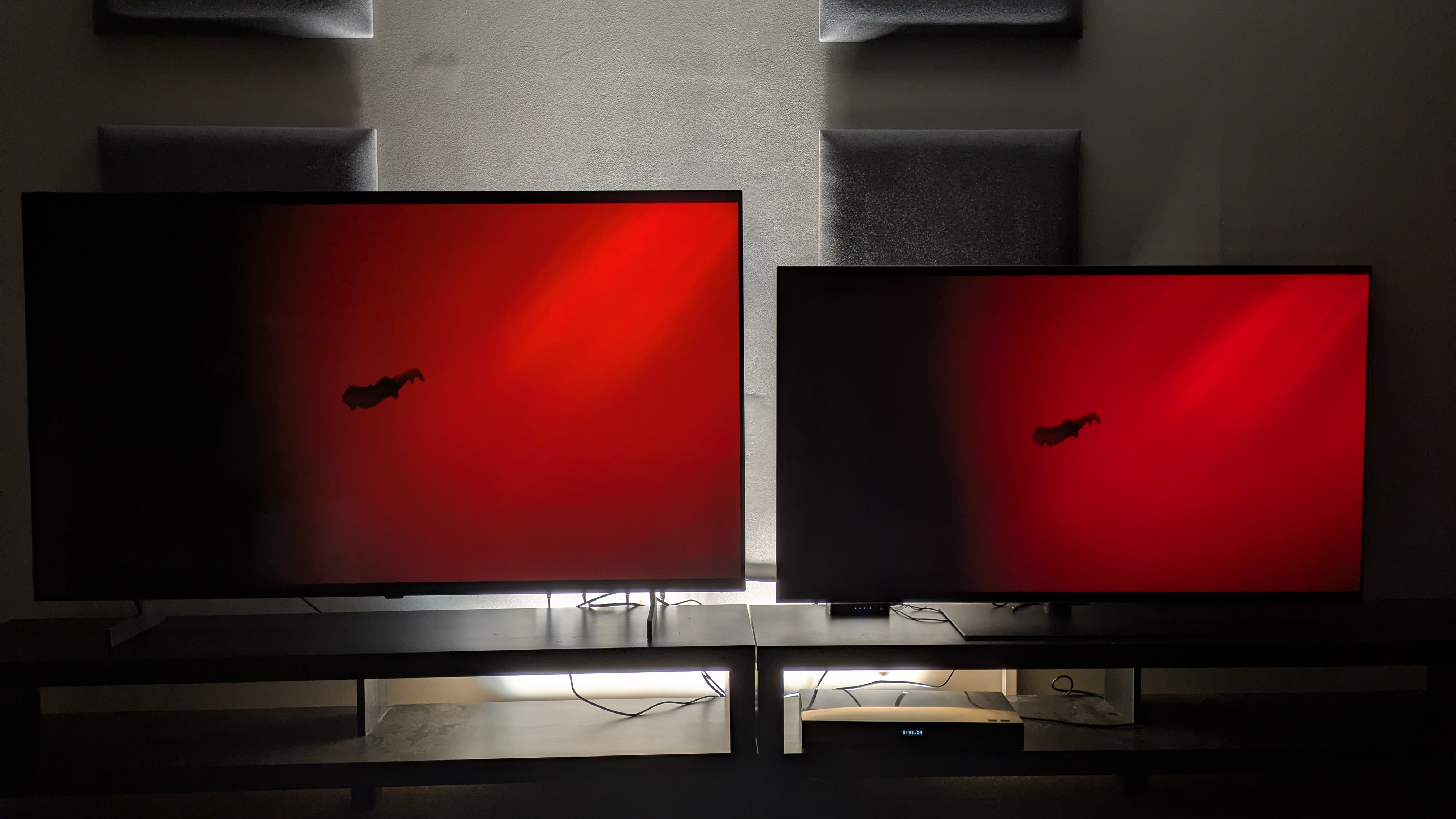 The LG B6 (left) and LG G6 (right) showing The Green Knight, with Gawain swimming in a dark lake with a large red area behind him. Both TVs show some color banding, but the G6's appears to be worse