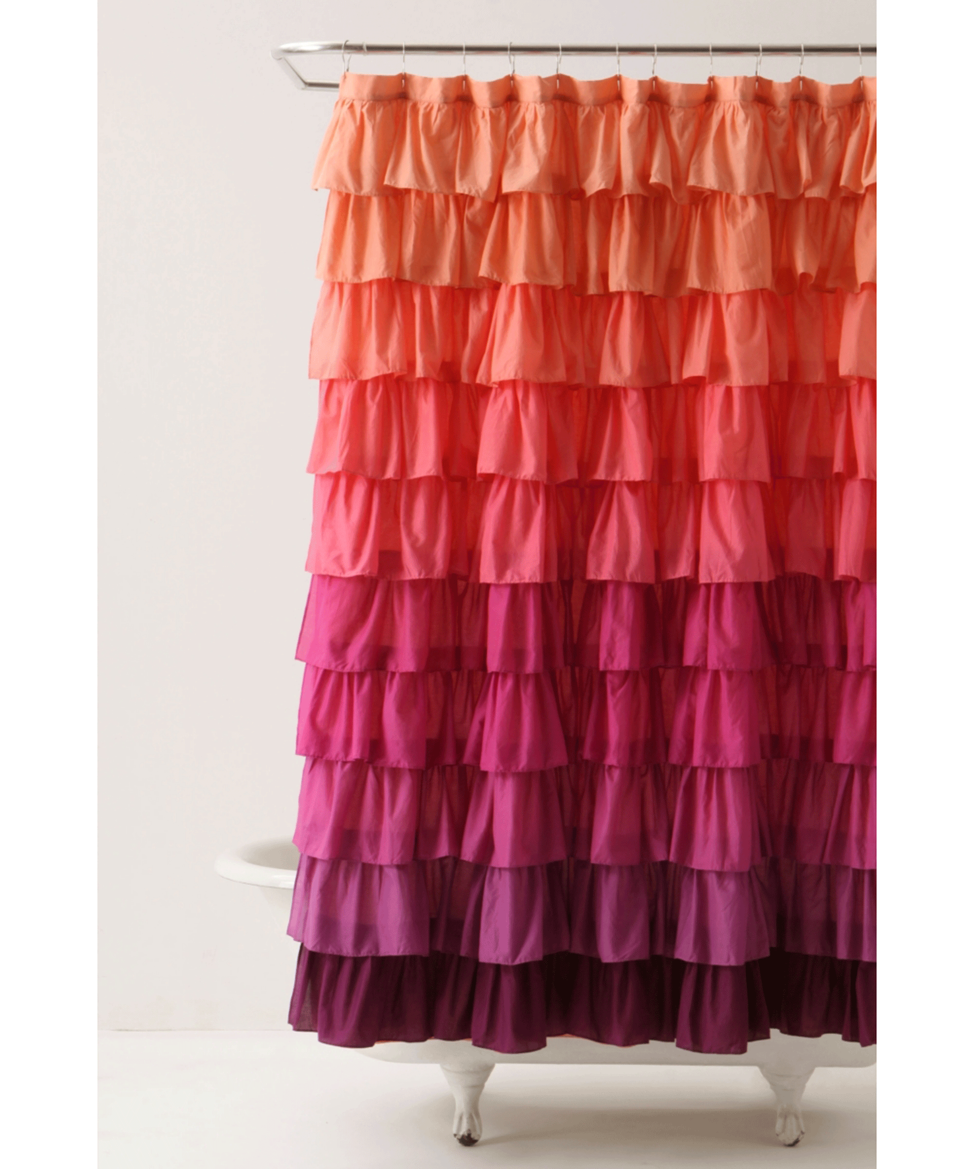 Frilly ombre shower curtain in shades of orange and pink over bath