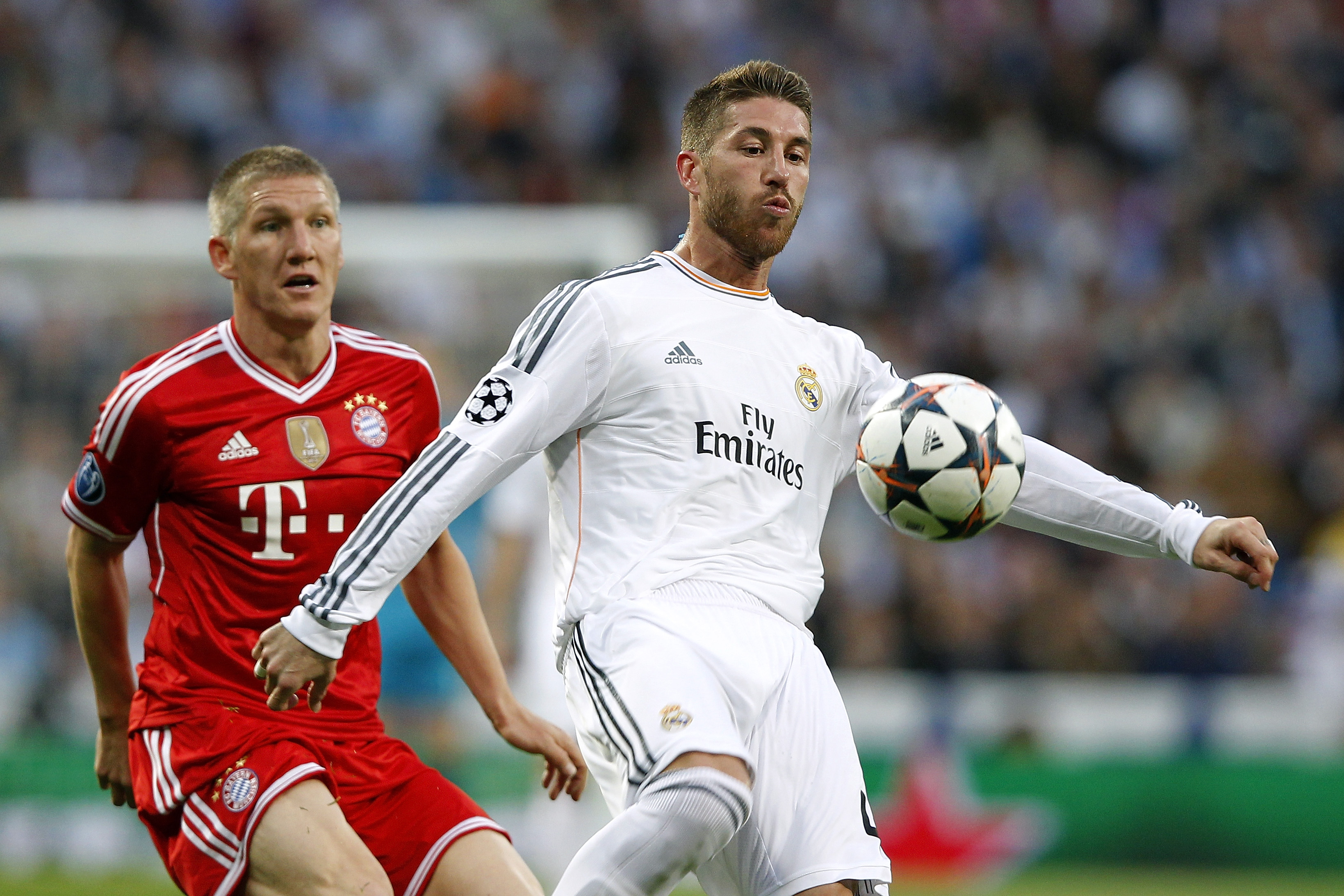 Real Madrid's Sergio Ramos competes for the ball with Bayern Munich's Bastian Schweinsteiger in the Champions League semi-finals in April 2014.