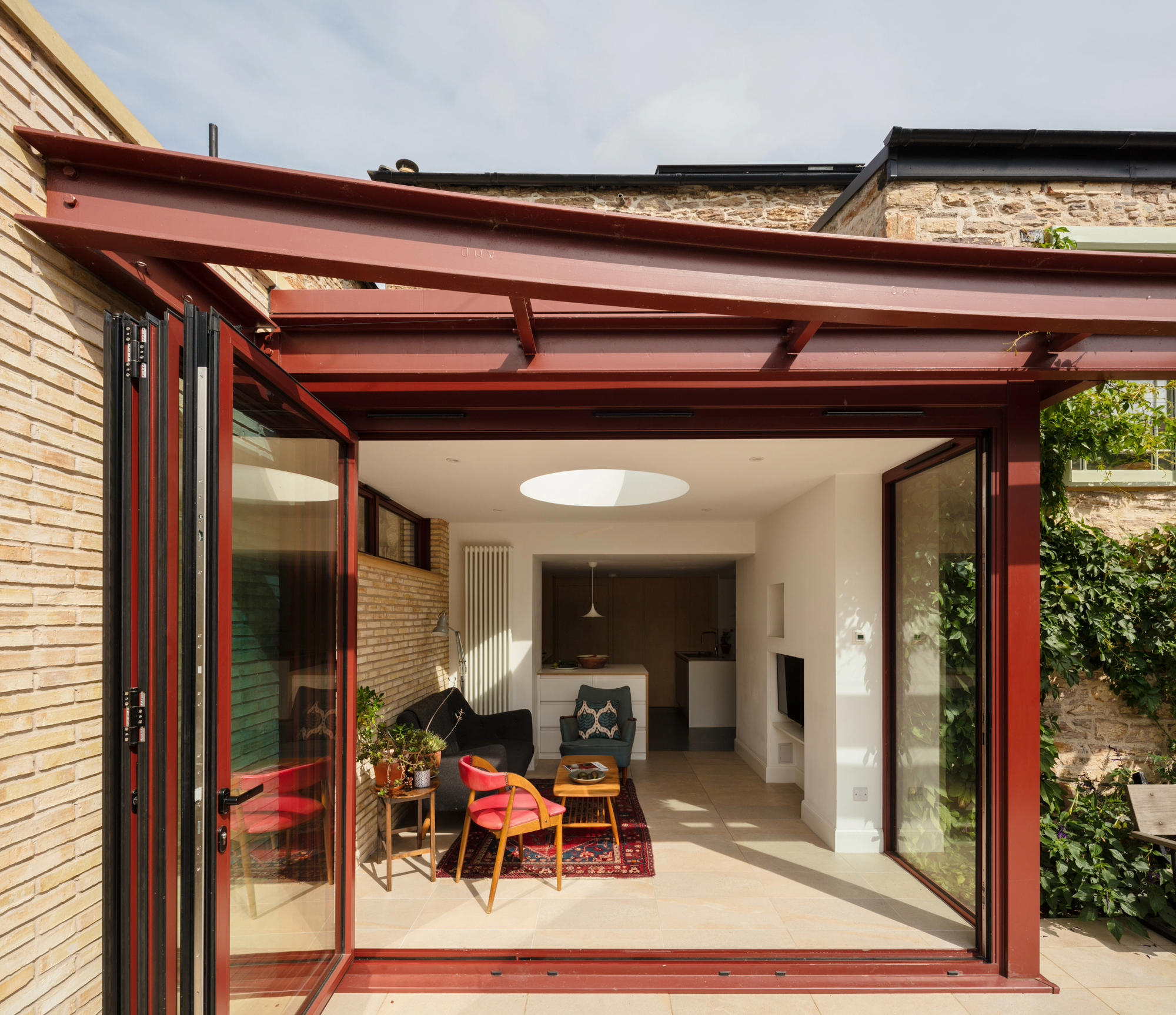 Modern metal pergola attached to an extension from a home