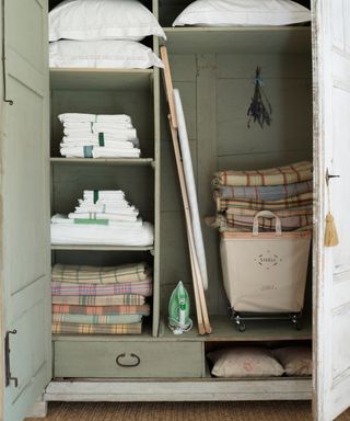 linen cupboard with towels and throws