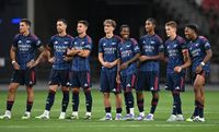 Jakub Kiwior, Mikel Merino, Martin Zubamendi, Max Dowman, Josh Nichols, Marli Salmon, Martin Odegaard and Myles Lewis-Skelly of Arsenal during the penalty shoot out after the pre season friendly between Arsenal and AC Milan at National Stadium on July 23, 2025 in Singapore.