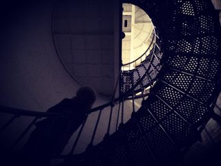 A person walks up the staircase at the St. Augustine Lighthouse