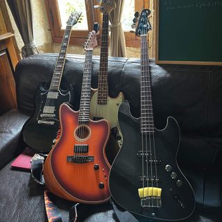 four guitars on a sofa