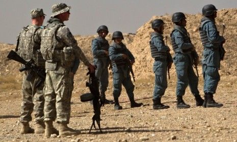 U.S. soldiers watch Afghan police recruits during a 2010 training session in Kabul: Some Afghan recruits will now need a village elder to vouch for them as part of tougher background checks.