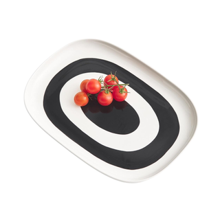 black and white rectangular serving dish with tomatoes on top