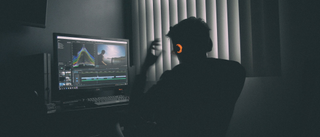 Man using video editing software at home