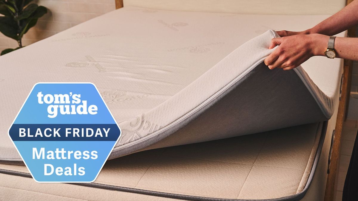 A woman lifts a bed topper with a Black Friday mattress topper sales badge