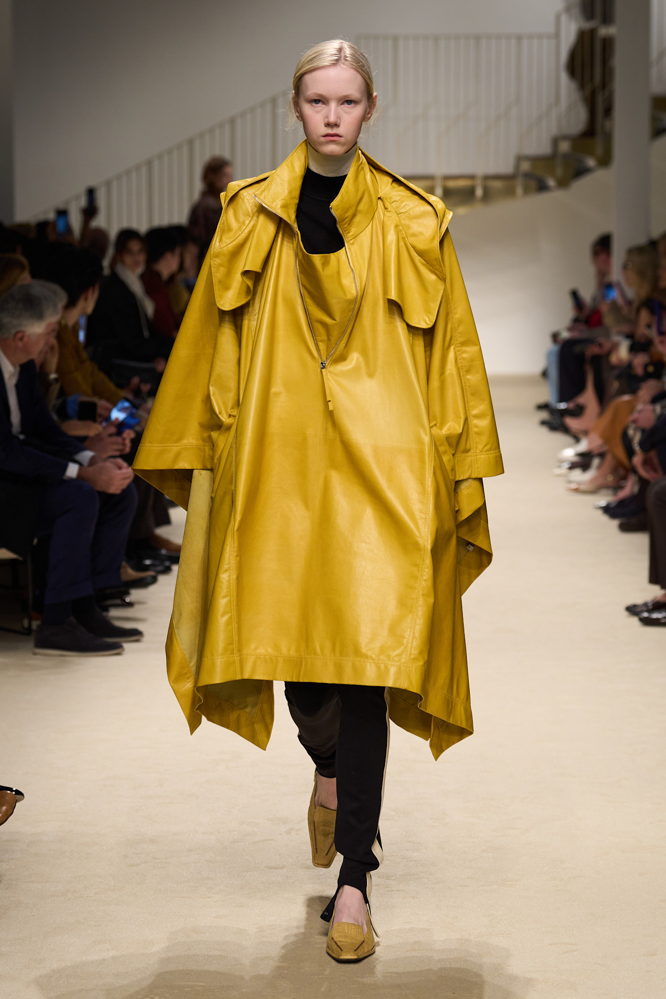 A model wore the mustard yellow color trend on the Tod's Fall 2026 runway