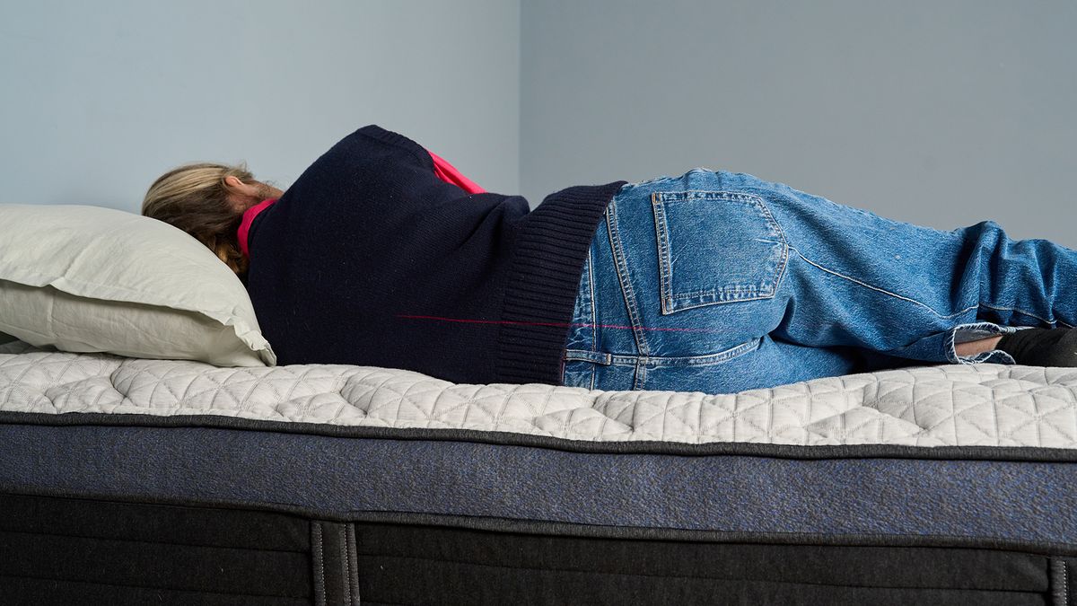 Nicola Appleton lies on her side on the Helix Midnight Luxe Mattress, to learn more about the pressure relief, comfort and support
