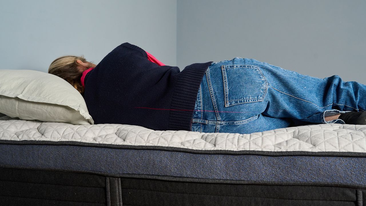 Nicola Appleton lies on her side on the Helix Midnight Luxe Mattress, to learn more about the pressure relief, comfort and support