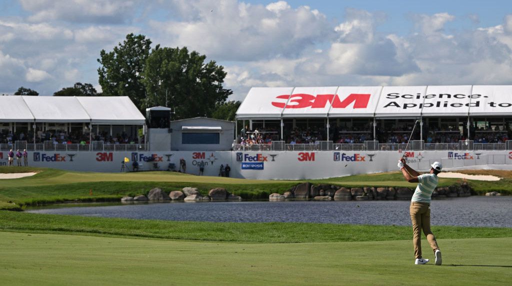 Tony Finau plays his approach to the 18th green during the final round of the 3M Open 2022 