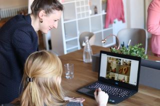 Stock photographs of people smiling and looking at laptops in a small business environment.