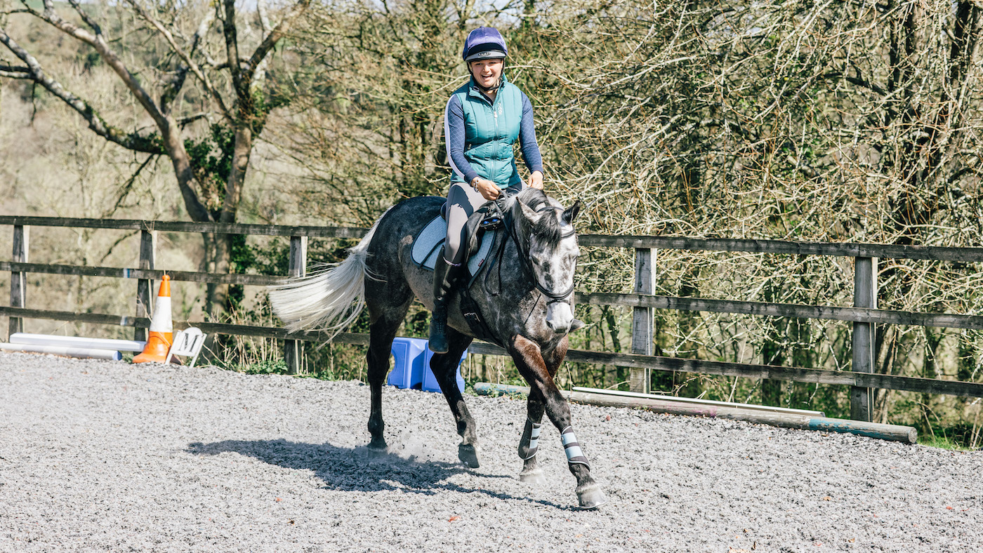 Trotting with no stirrups, rider smiling