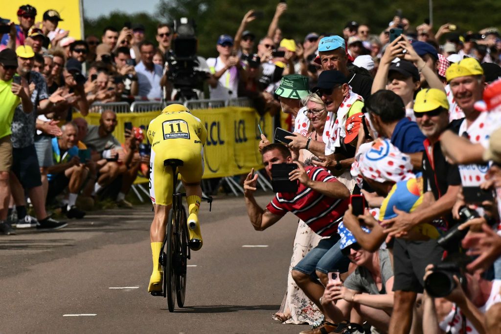 UAE Team Emirates team's Slovenian rider Tadej Pogacar wearing the overall leader's yellow jersey cycles during the 7th stage of the 111th edition of the Tour de France cycling race, 25,3 km individual time trial between Nuits-Saint-Georges and Gevrey-Chambertin, on July 5, 2024. (Photo by Marco BERTORELLO / AFP)