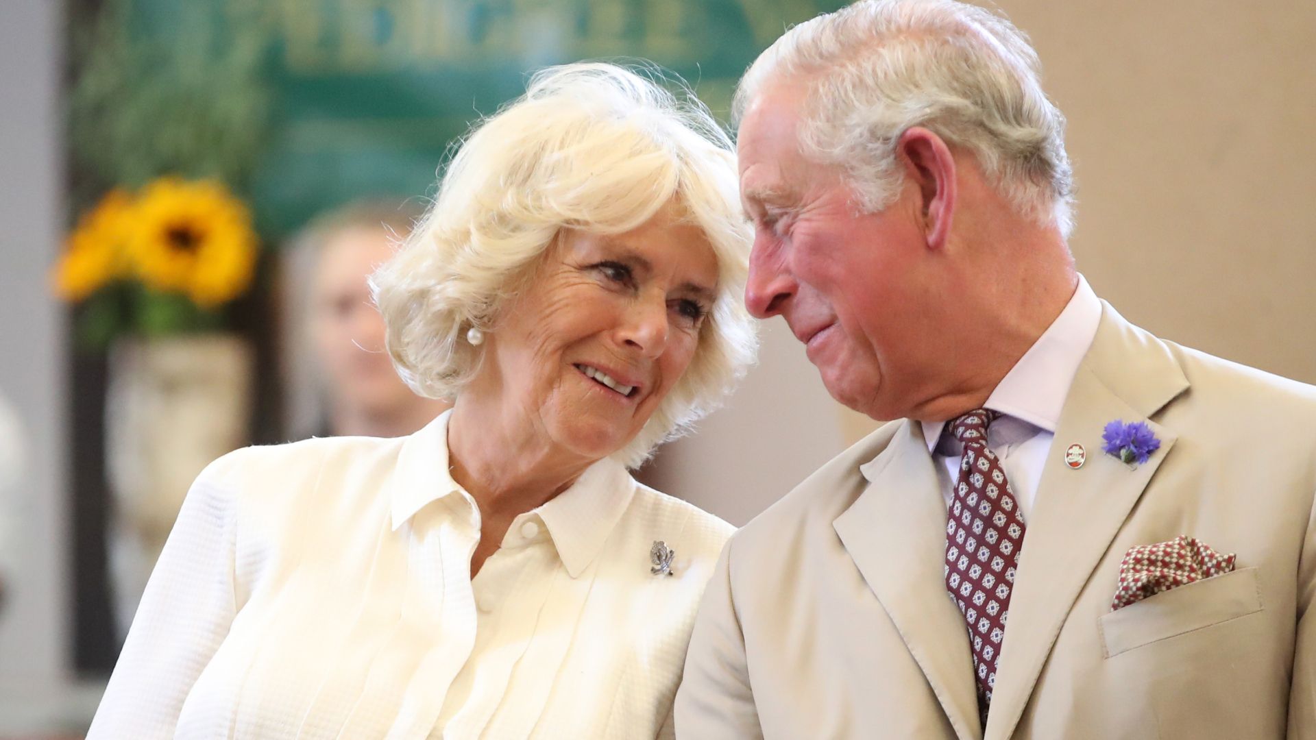 Queen Camilla smiling at King Charles.