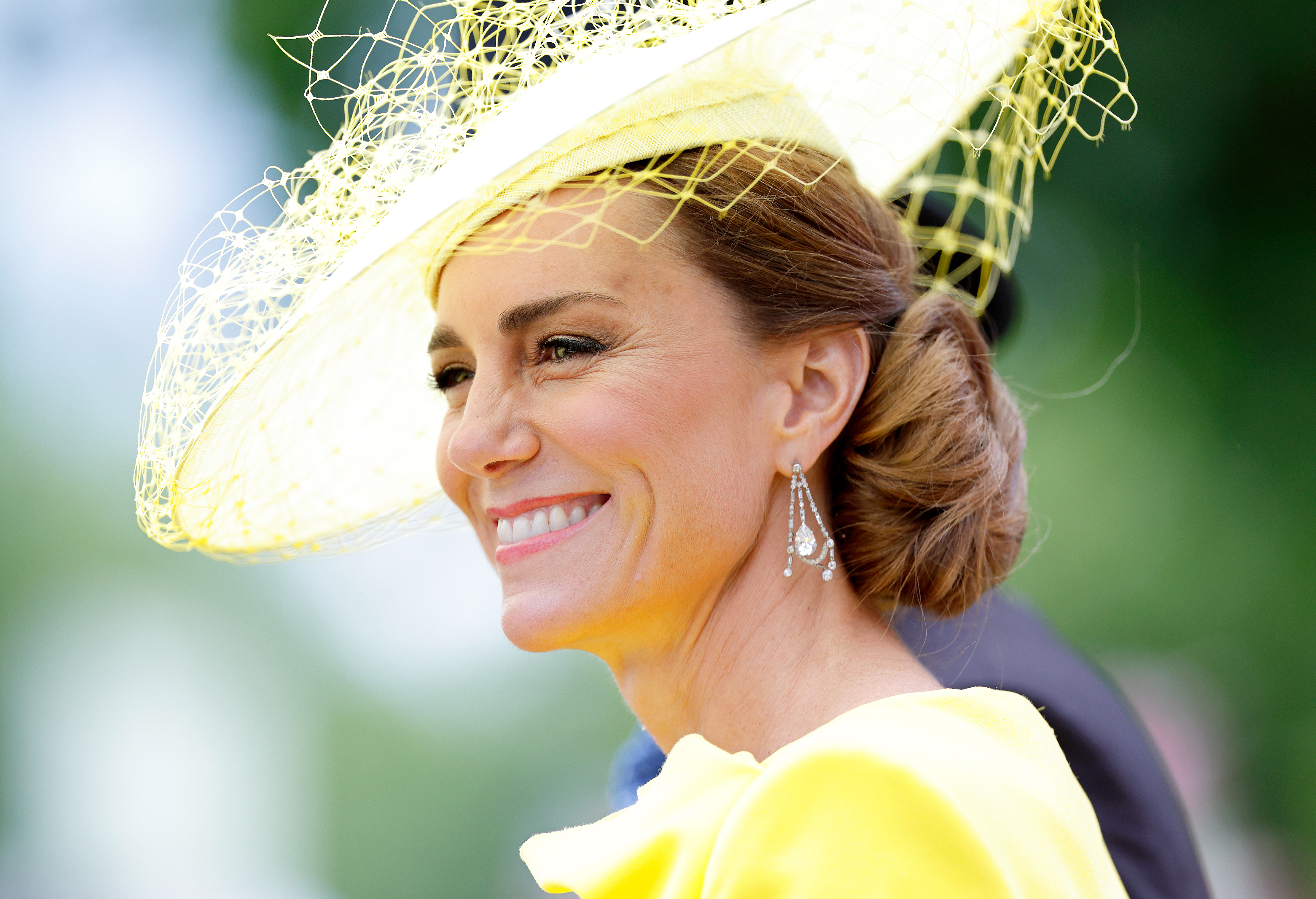 Princess Kate wearing a yellow hat and dress