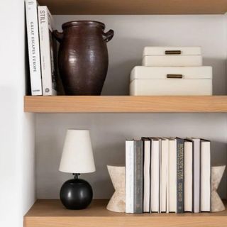 Two white storage boxes on open wooden shelving from McGee & Co.