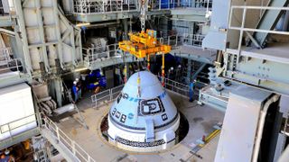 Boeing's Starliner CST-100 capsule has been mounted on top of the Atlas V rocket ahead of its second unmanned test flight to the International Space Station.