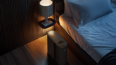 A bed with a sleep pod beside the floating nightstand