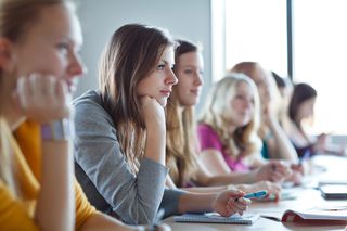 Teens sit in a high school classroom