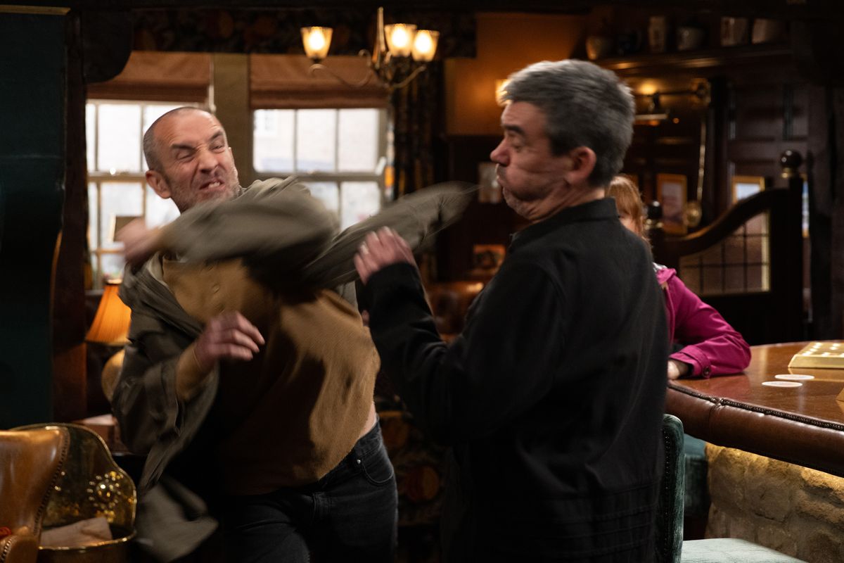 Sam lashes out at Cain in the Woolpack, Emmerdale. 