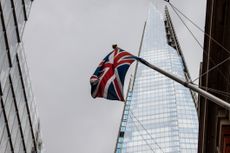 British flag waving in front of The Shard over a cloudy day