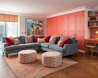 colorful playroom with coral cupboard doors, gray sofa and patterned cushions