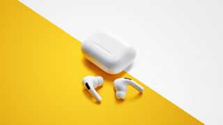 A set of AirPods Pro on a white and orange background