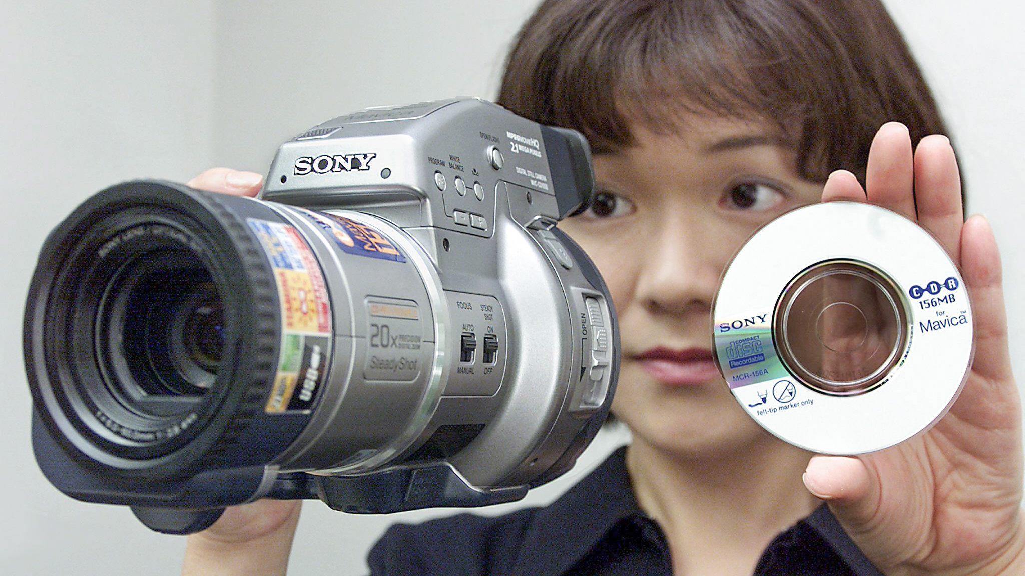 Fumie Kagaya, an employee of Japan's Sony Marketing Inc., displays its new Mavica &amp;quot;MVC-CD1000&amp;quot; at Sony head office in Tokyo, 01 August 2000. The digital still camera, which measures 137x131x212 mm and weighs 870 grams, uses a 156MB CD-R recording media as storage device. Up to 160 pictures with 1600x1200 resolution can be recorded on a single CD-R disc. The unit is now on sale with a price of 175,000 yen (USD$1,600.00). (Photo by KAZUHIRO NOGI/AFP via Getty Images)