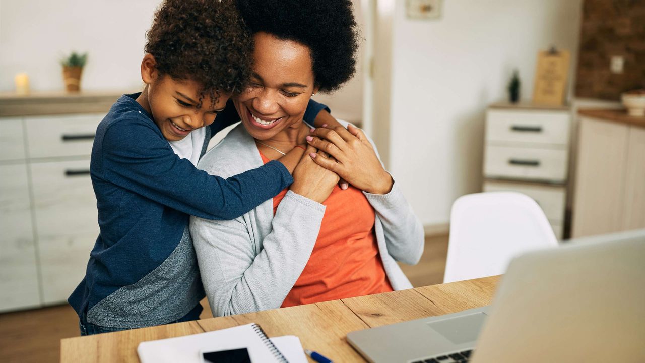 A young son hugs his happy mom.