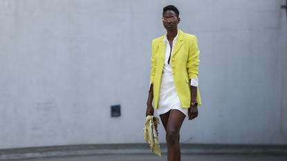 woman in mini skirt outfit, white mini skirt, shirt, yellow blazer