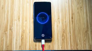 OnePlus 9 Pro with plugged in charging cable