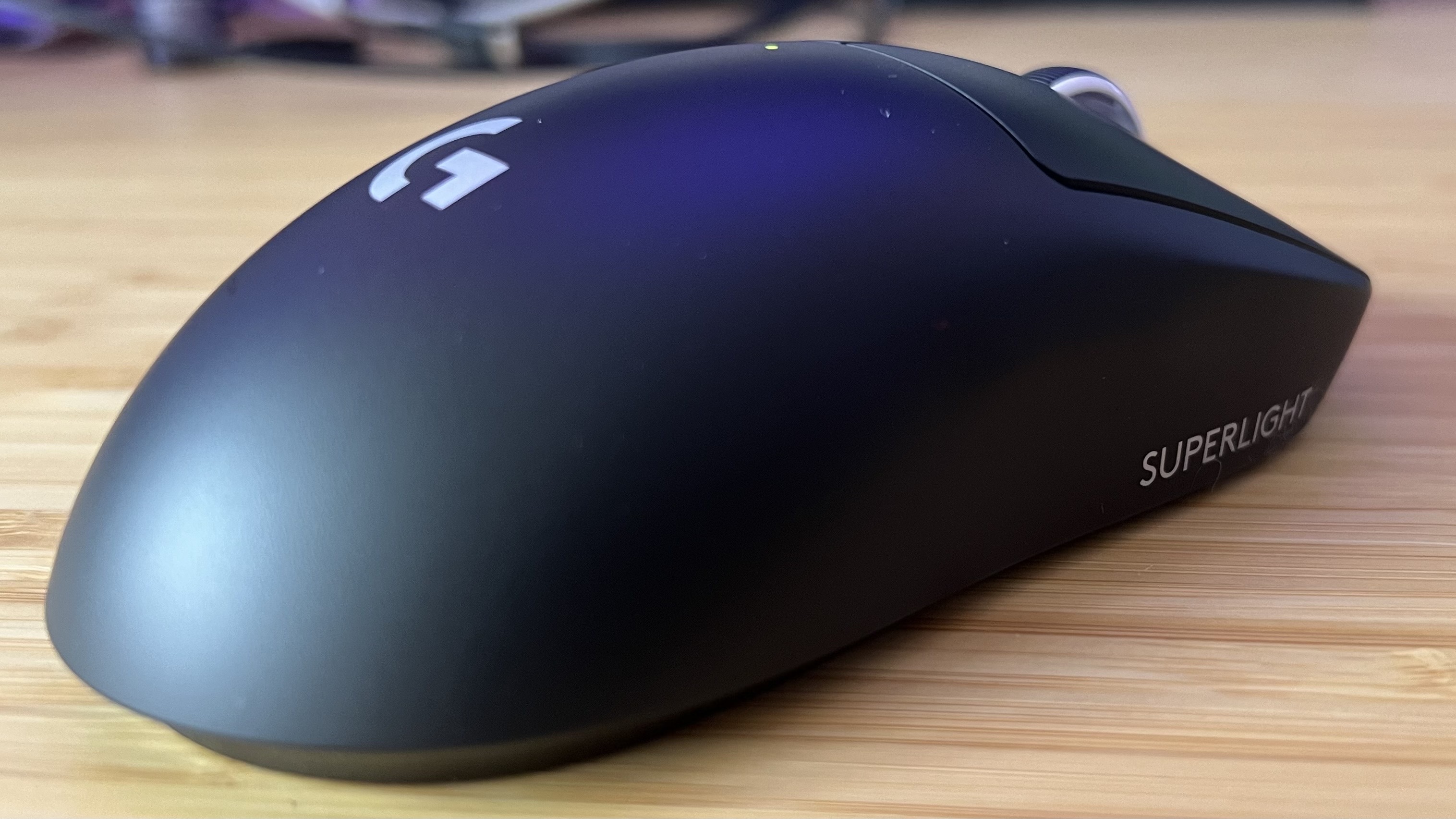 Logitech G Pro X Superlight 2 from the side on a wooden table