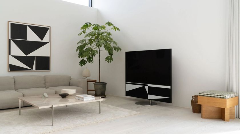 Samsung The HiFi Frame TV in a neutrally decorated room displaying a geometric artwork similar to a black and white one on the wall opposite it