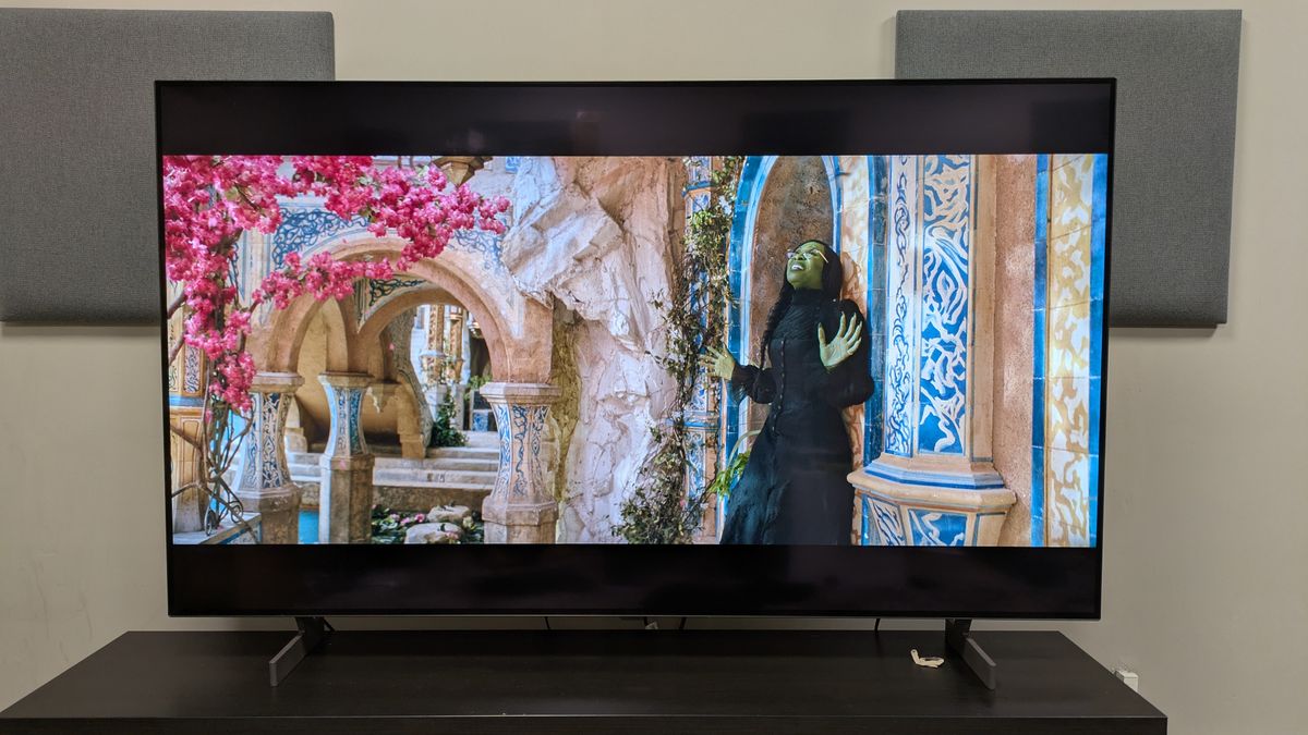 LG B6 OLED TV with a shot of Elphaba standing under a tree with pink flowers, from Wicked. The B6 makes the pink flowers punchy and bold, while shwoing good color accuracy in other parts of the screen